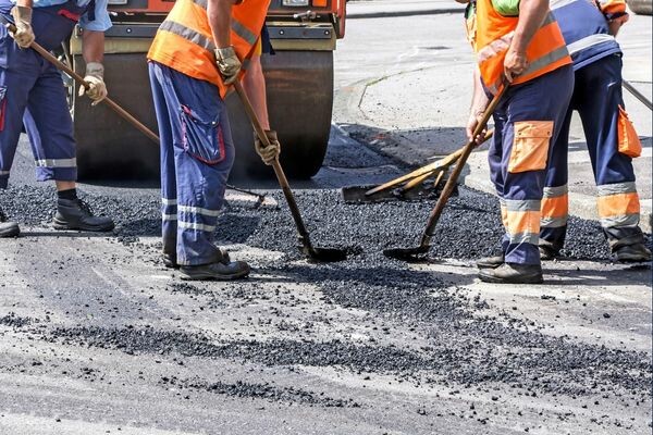 Construction workers with orange vests